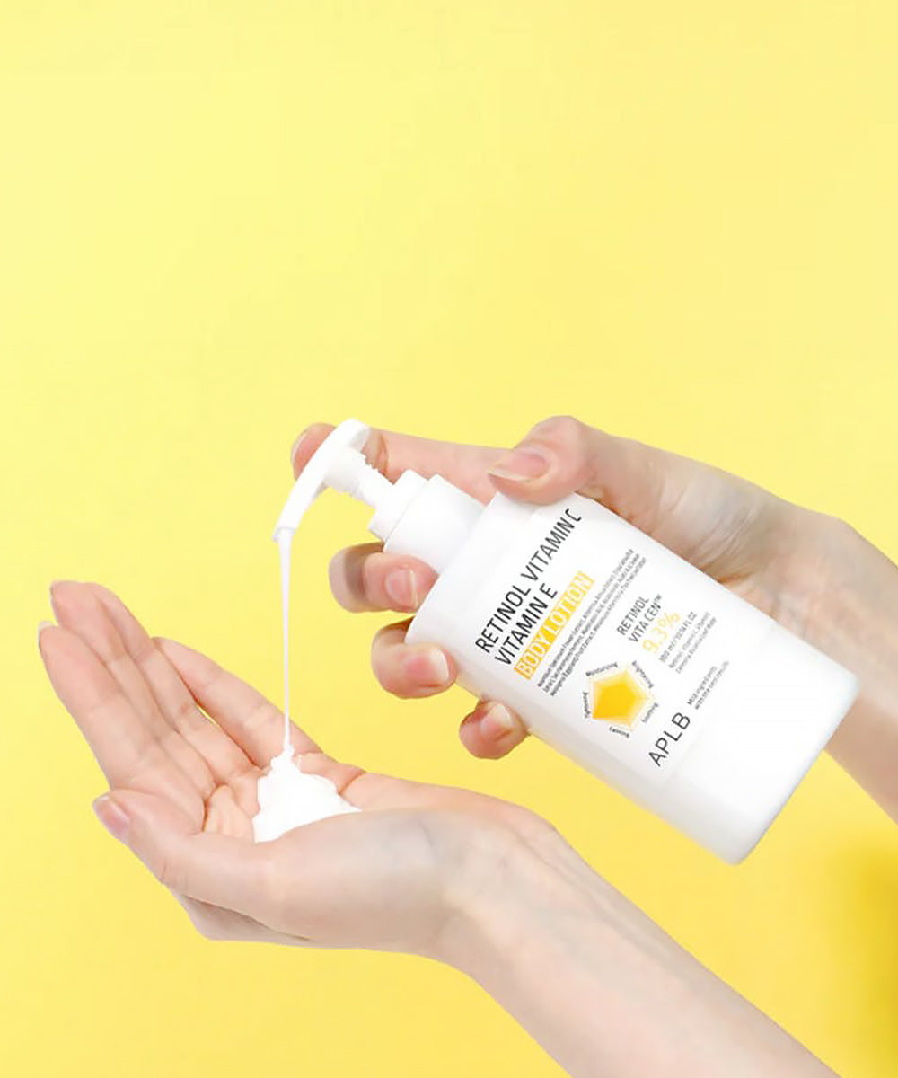 Hand holding a bottle of lotion with a yellow background