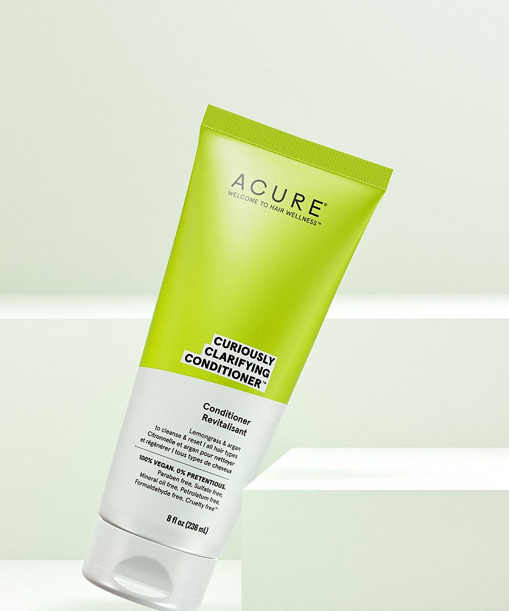 Acure Curiously Clarifying Conditioner tube on a light green background