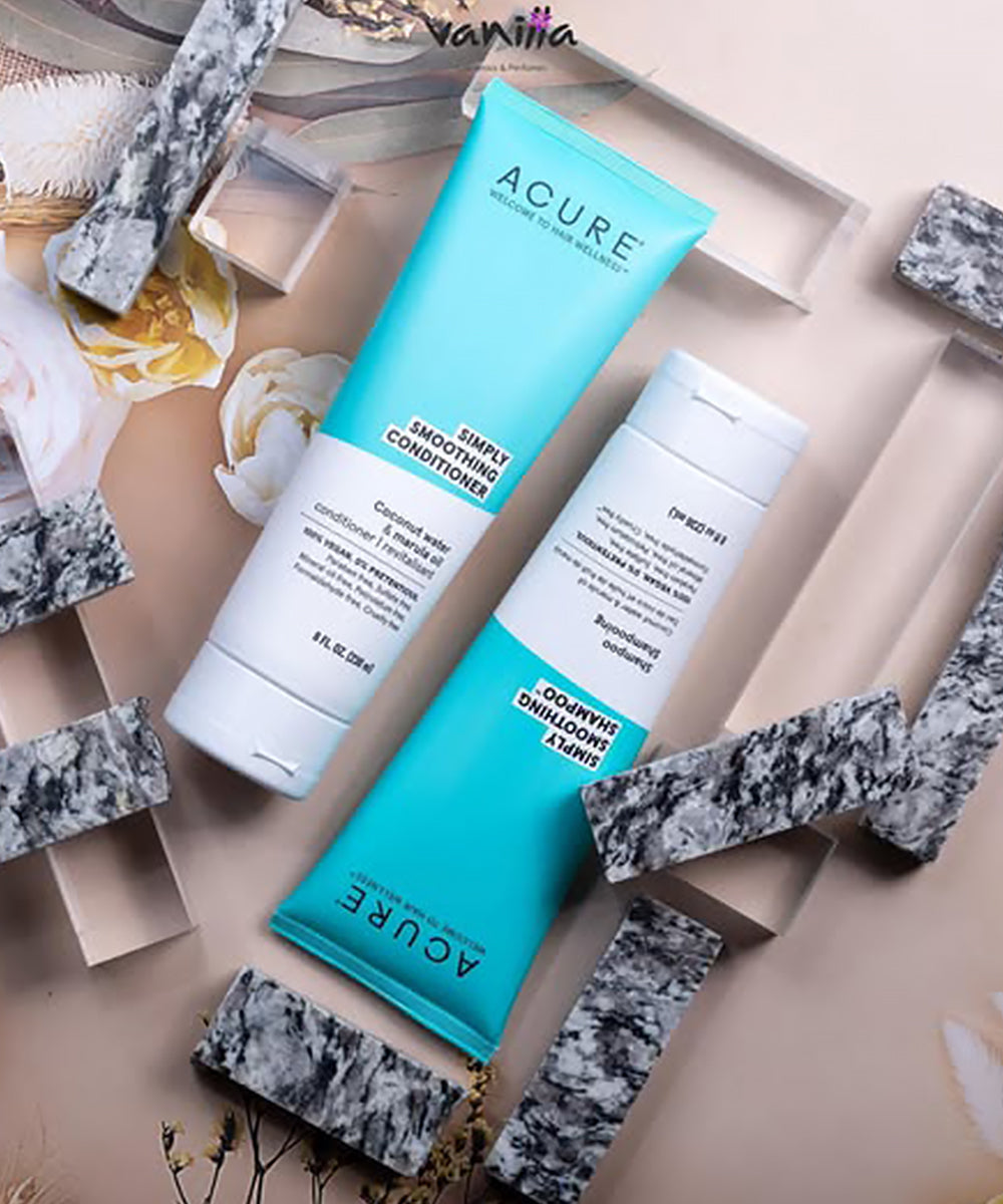 Two Acure skincare products on a decorative background with stones and flowers.