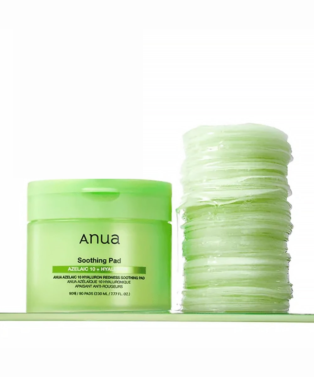 Green jar of 'Anua' soothing pad with multiple pads stacked beside it on a white background