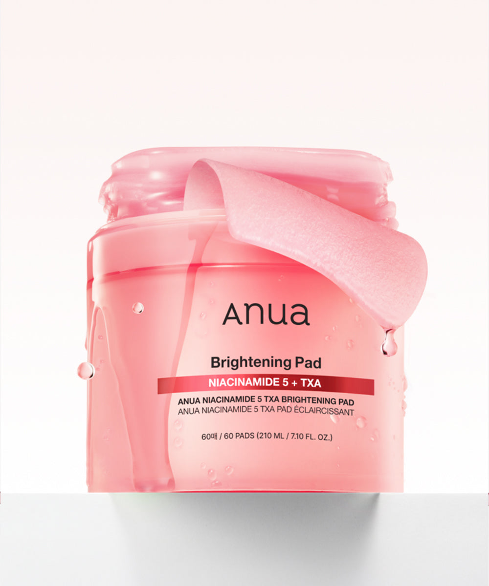 Pink jar of Anua Brightening Pad on a white background
