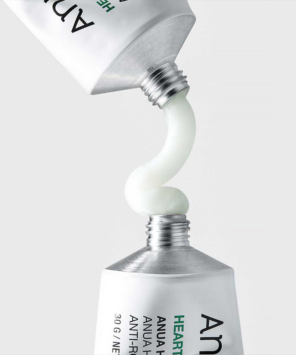 Close-up of a skincare product being squeezed out of a tube with a white background