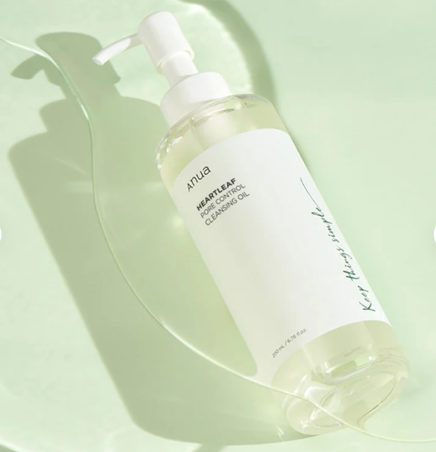 Skincare bottle with pump on a light green background