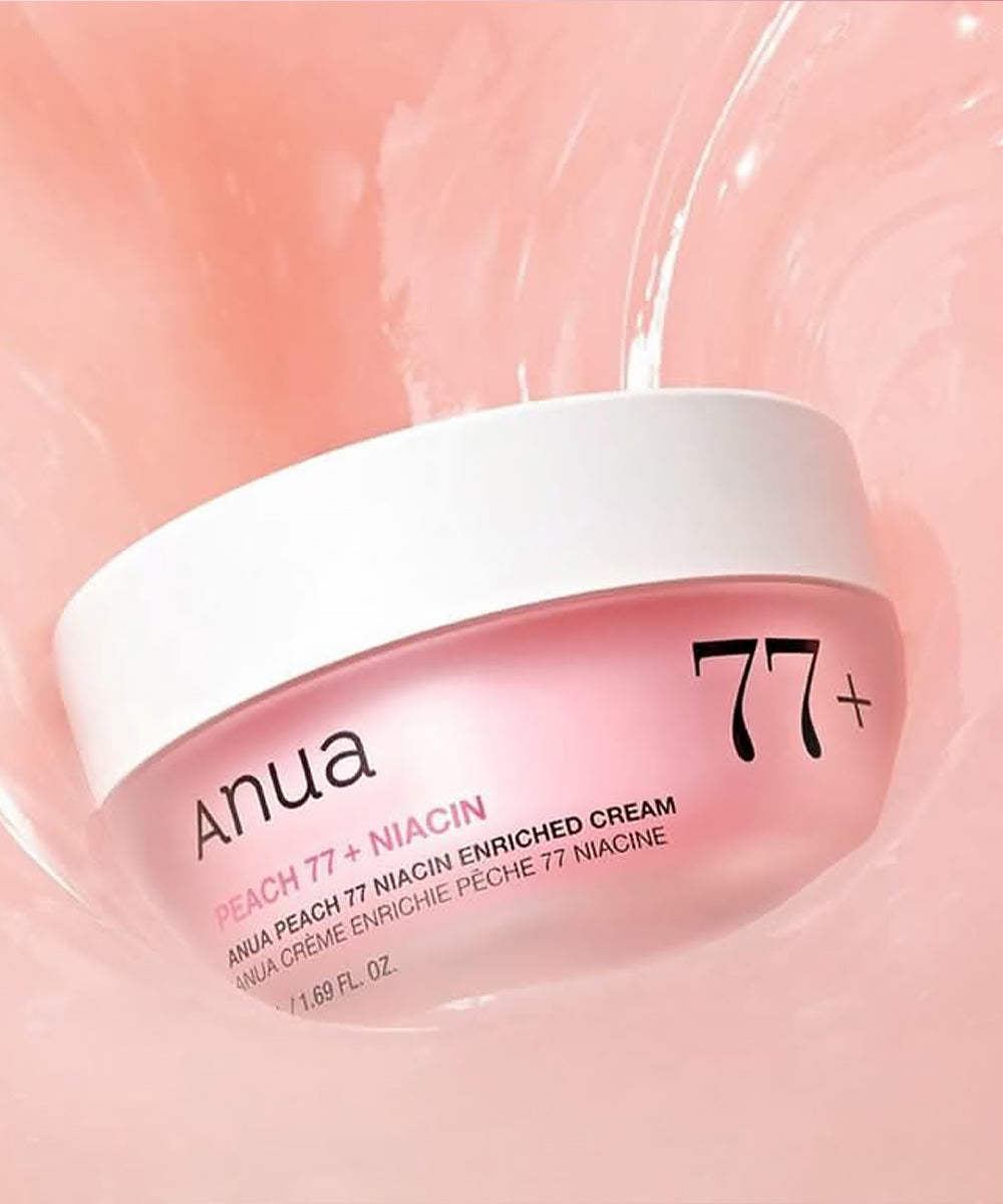 Anua Peach 77+ Niacin enriched cream jar on a pink background