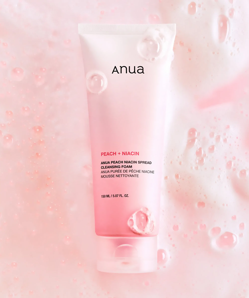 Anua Peach + Niacin cleansing foam packaging on a pink background with bubbles