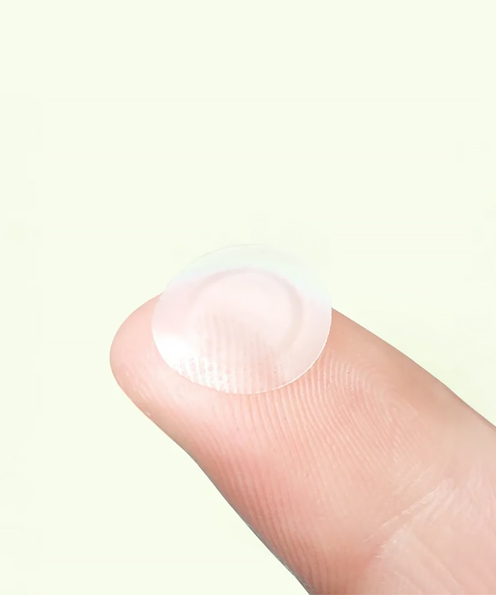 Clear patch on a finger against a light background