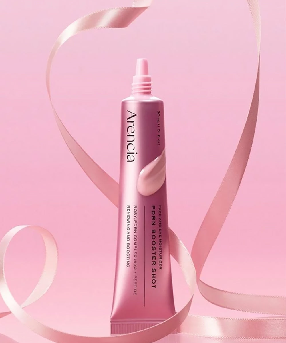 Professional promotional image of the Arencia PDRN Booster Shot moisturizer elegantly framed by a swirling pink silk ribbon, highlighting its renewing and boosting properties
