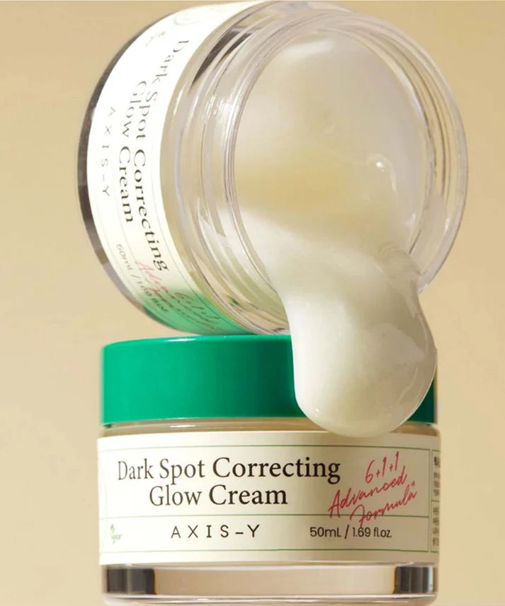 AXIS-Y Dark Spot Correcting Glow Cream jar with cream oozing out on a beige background