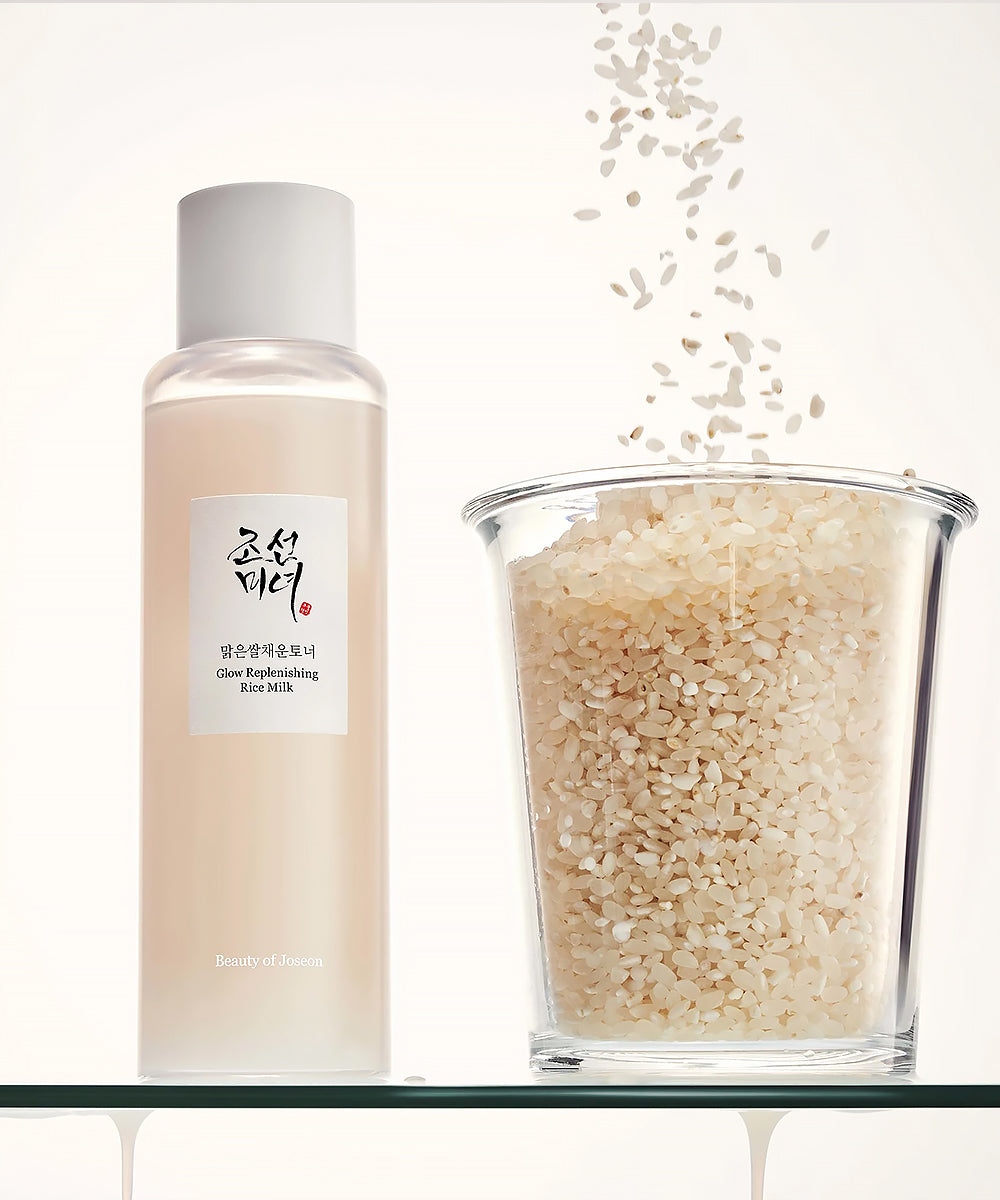 Skincare product bottle with a glass container of rice scrub on a white background