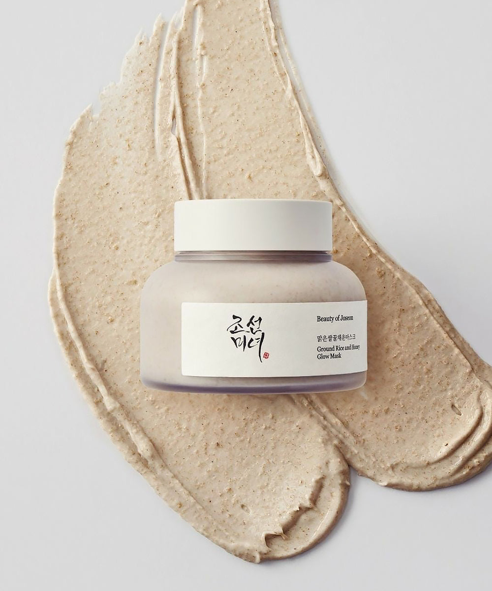 Jar of cream with a beige paste on a light gray background