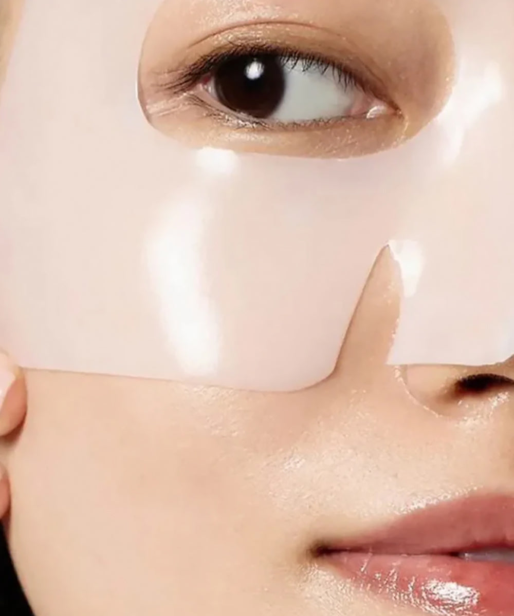 Close-up of a person wearing a white eye mask on their face.