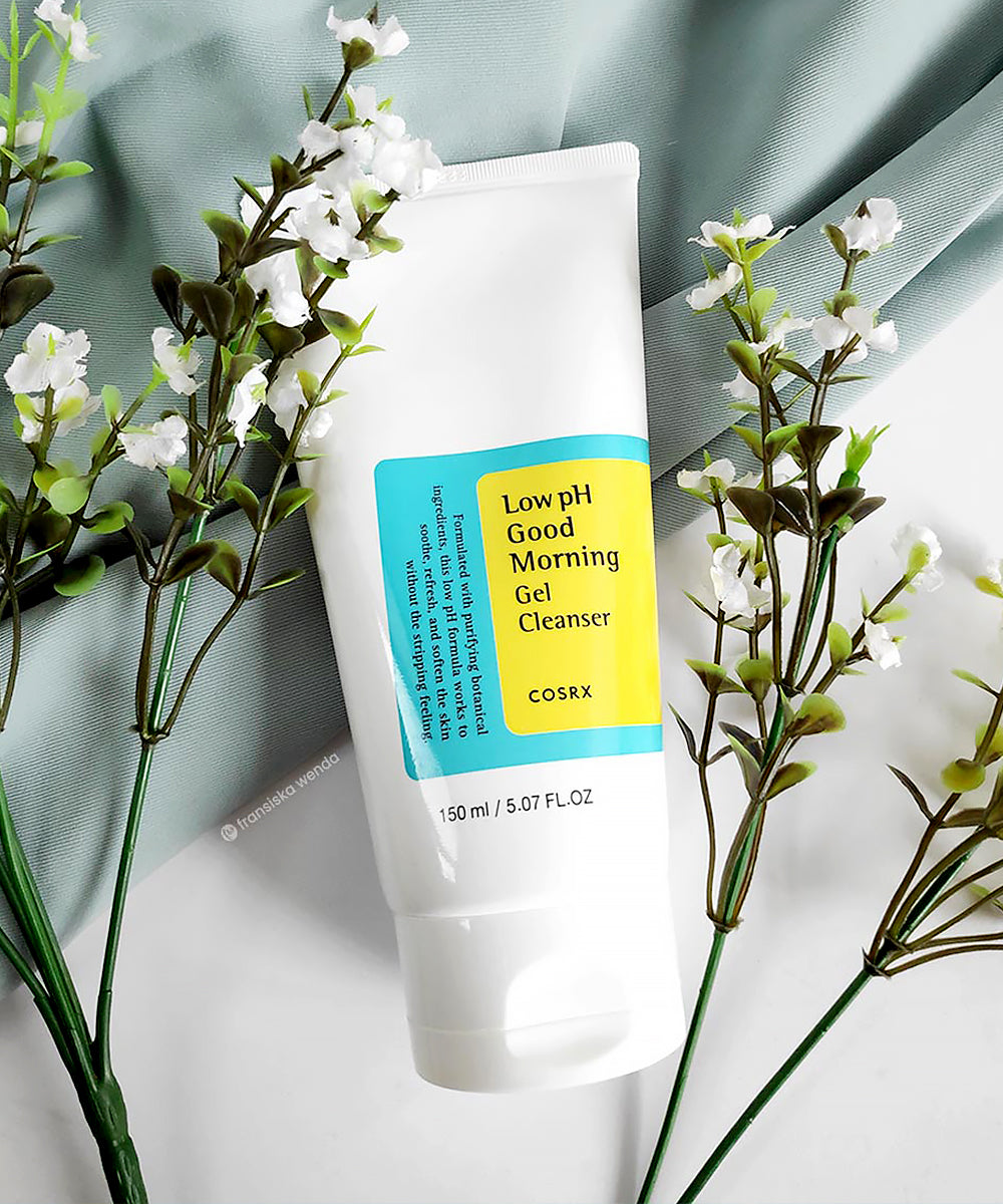 CosRX Low pH Good Morning Gel Cleanser tube with flowers on a light background