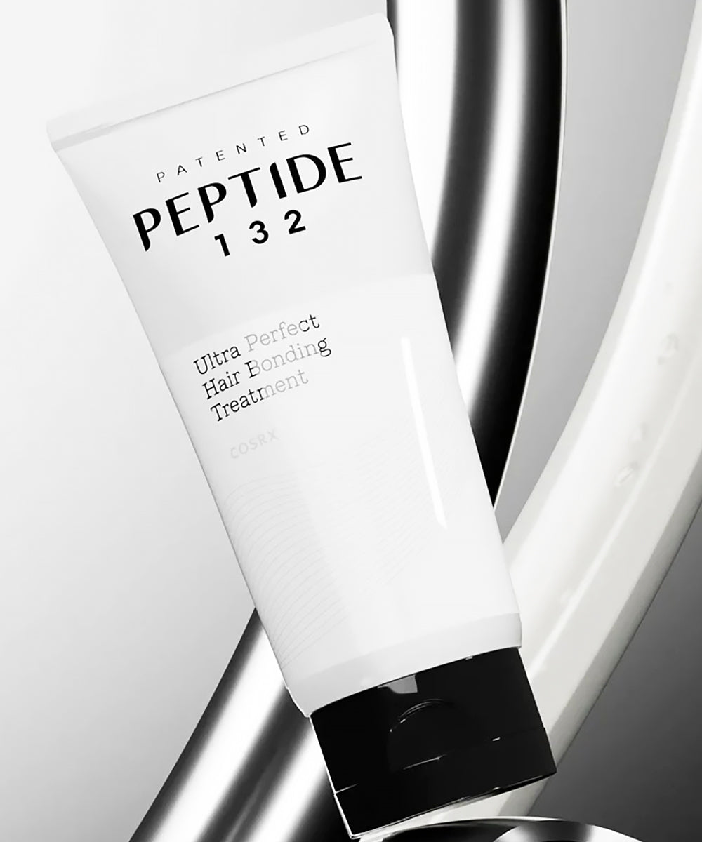 White hair treatment tube labeled 'Peptide 132' on a reflective silver background