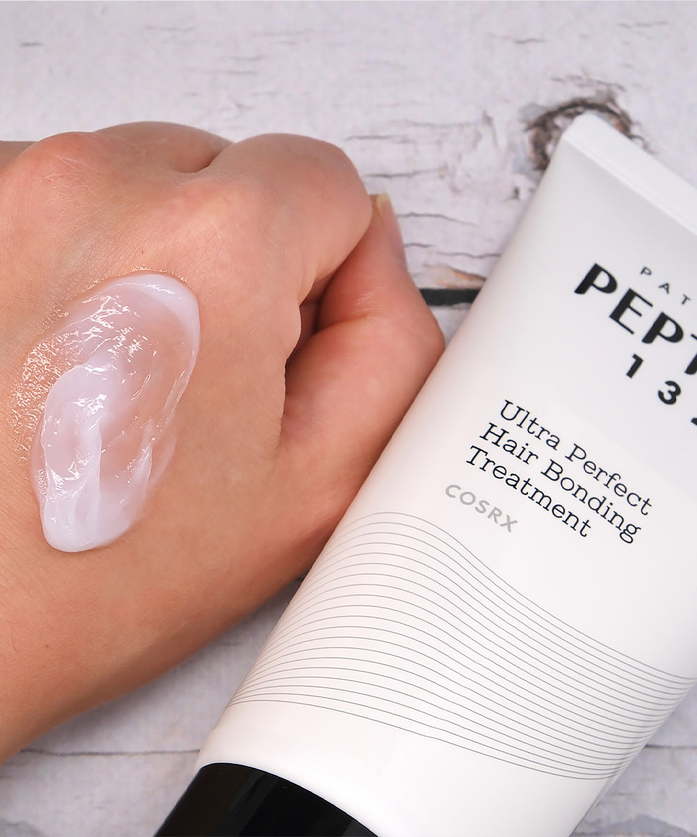 COSRX Ultra Perfect Hair Bonding Treatment being applied to a hand
