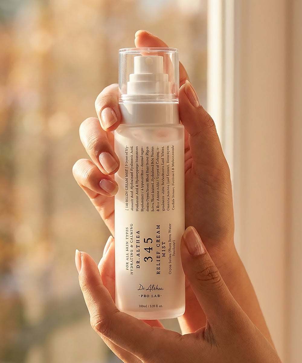 Hand holding a skincare bottle labeled '345' with a blurred background