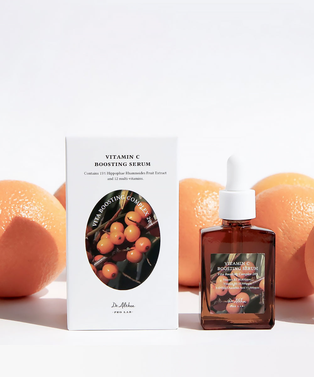 Vitamin C boosting serum with packaging and oranges on a white background