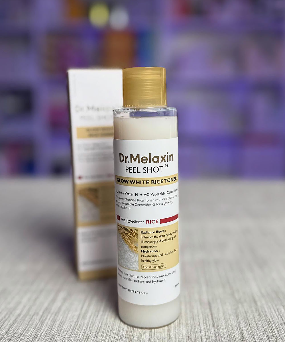Dr. Melaxin peel shot glow white rice toner bottle on a surface with a blurred background
