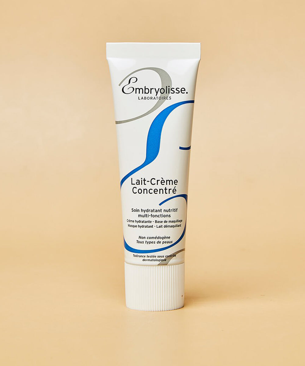 Tube of Embryolisse Lait-Crème Concentré on a beige background