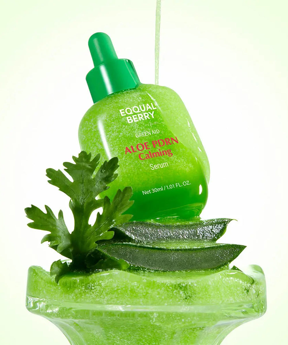 Green aloe vera serum bottle with leaves on a white background