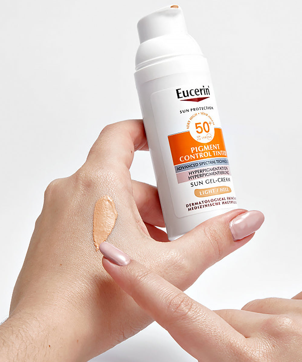 Eucerin sunscreen gel-cream being applied to a hand with a small amount on the skin.