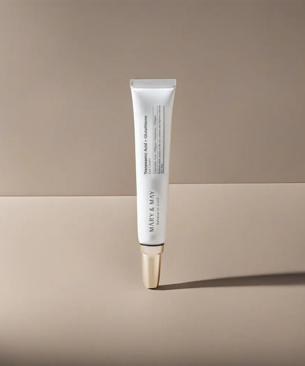 Skincare tube with gold cap on a beige background