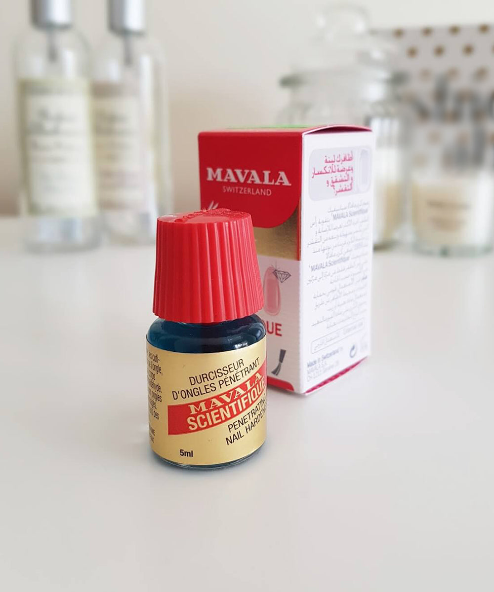 Mavala nail care product with red cap on a white surface