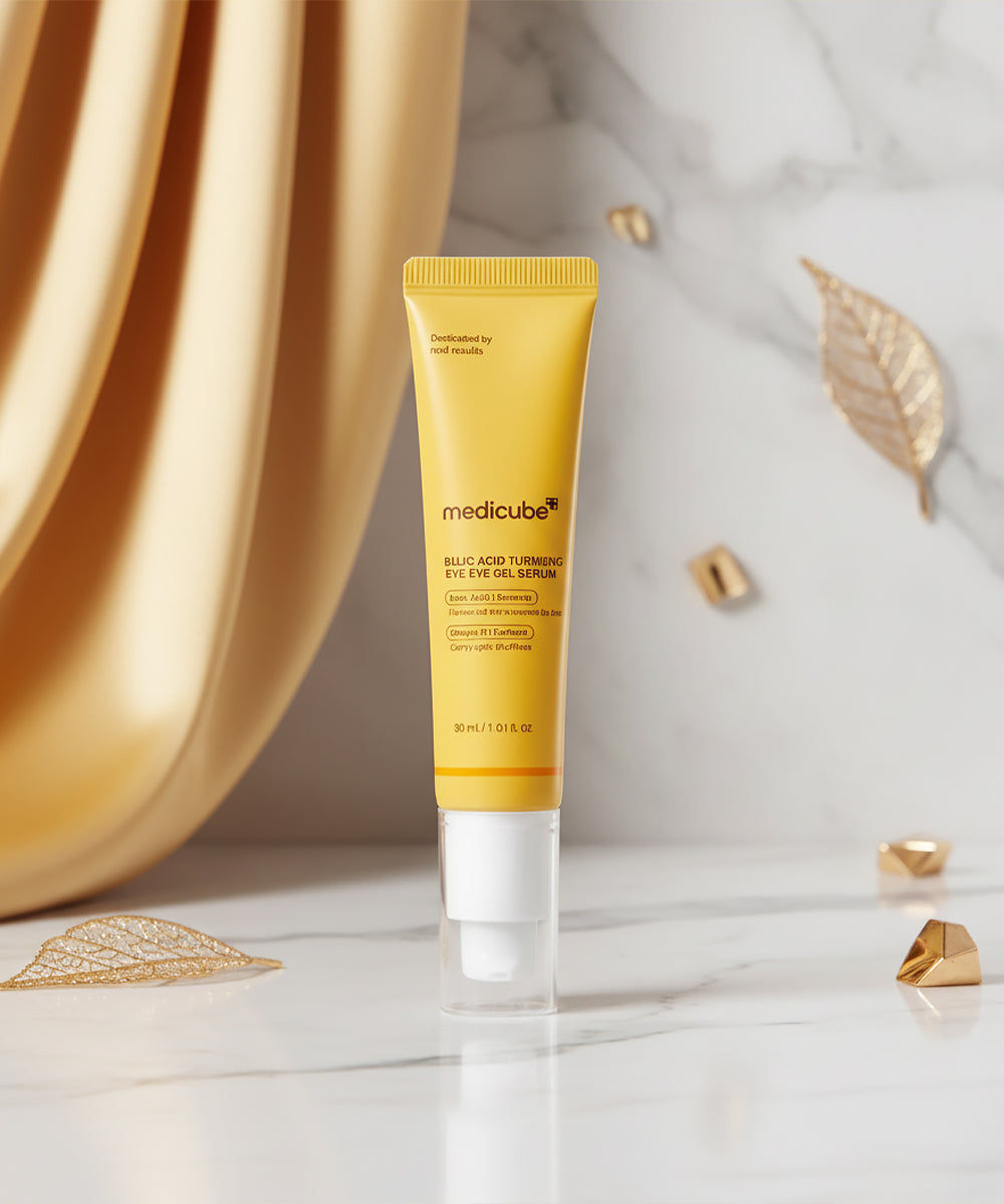 The Medicube Kojic Acid Turmeric Eye Serum and its outer packaging displayed under bright, professional lighting, reflecting a high-end dermatological skincare aesthetic