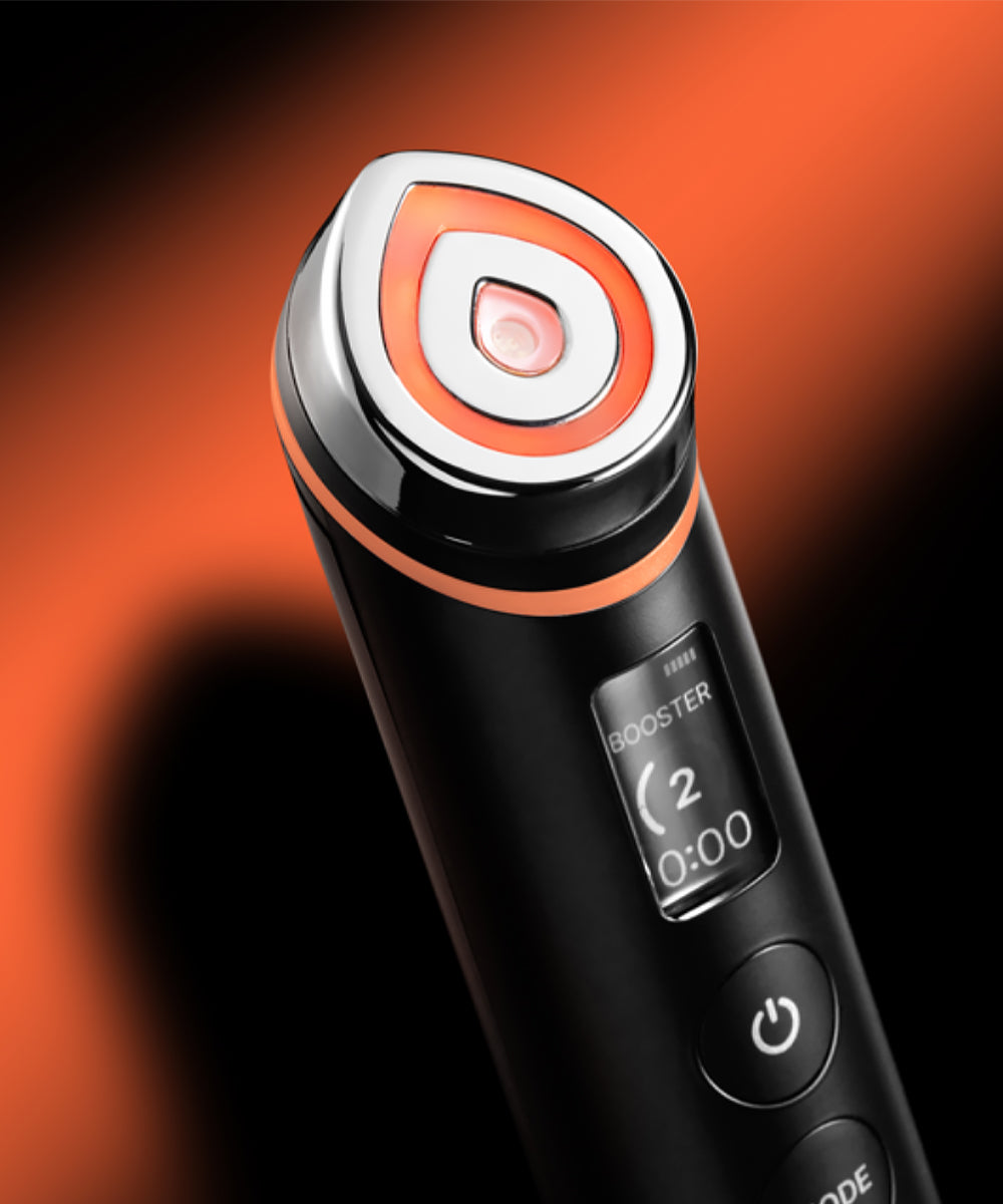 Black and orange electronic device with digital display on a dark background