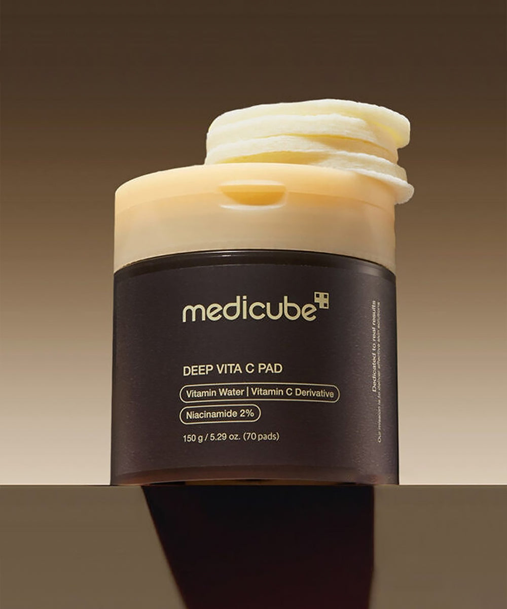 Jar of Medicube Deep Vita C Pad with cream on top against a gradient background