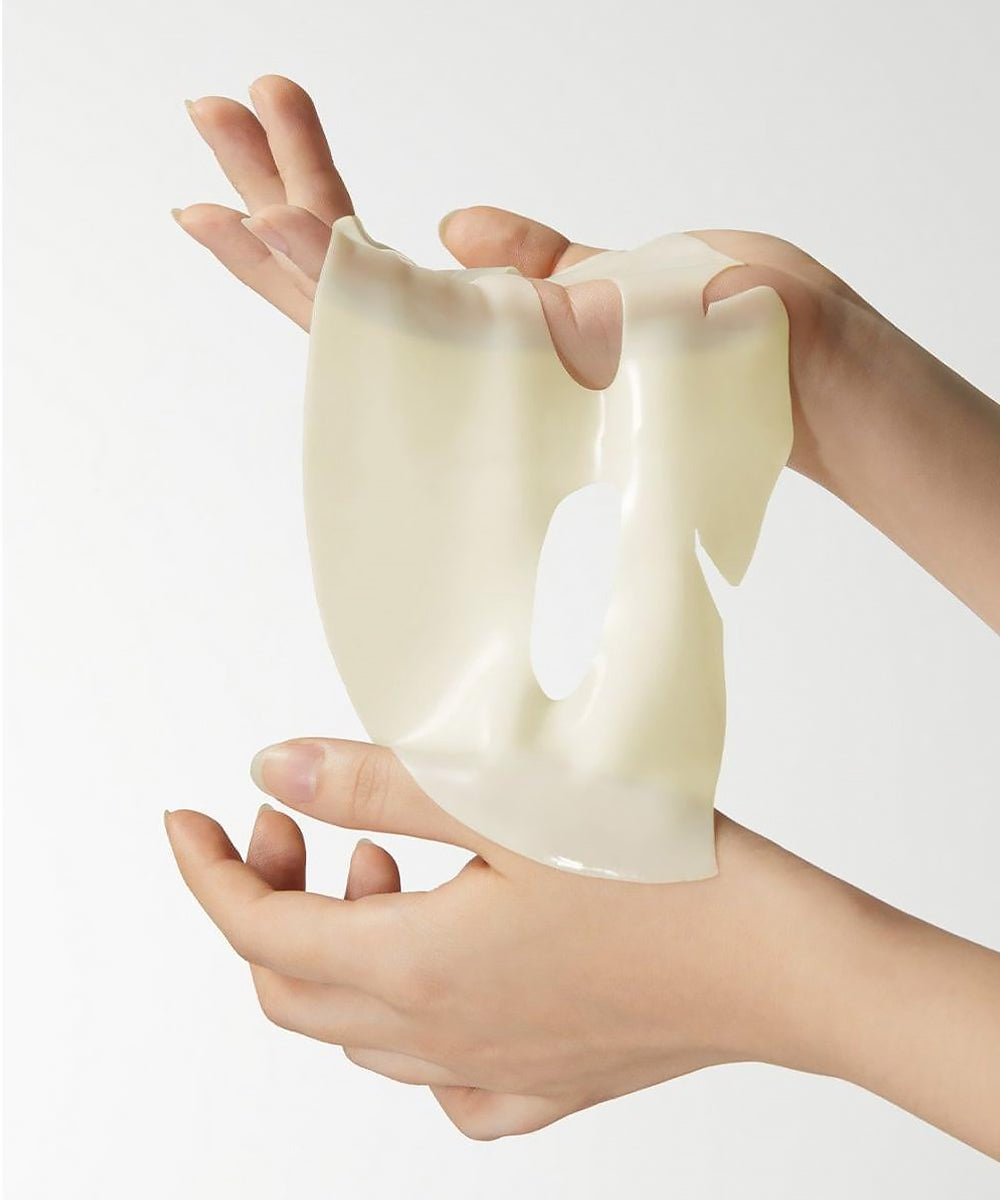 Hands holding a piece of white silicone gel on a light gray background