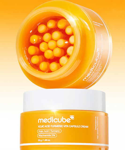 Orange jar of Medicube cream with visible capsules on a yellow background