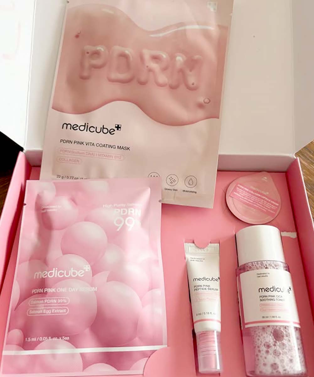 Medicube skincare product set with pink packaging on a white background