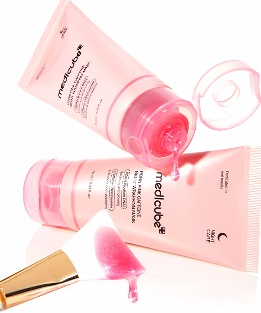 Pink skincare product with applicator on a white background