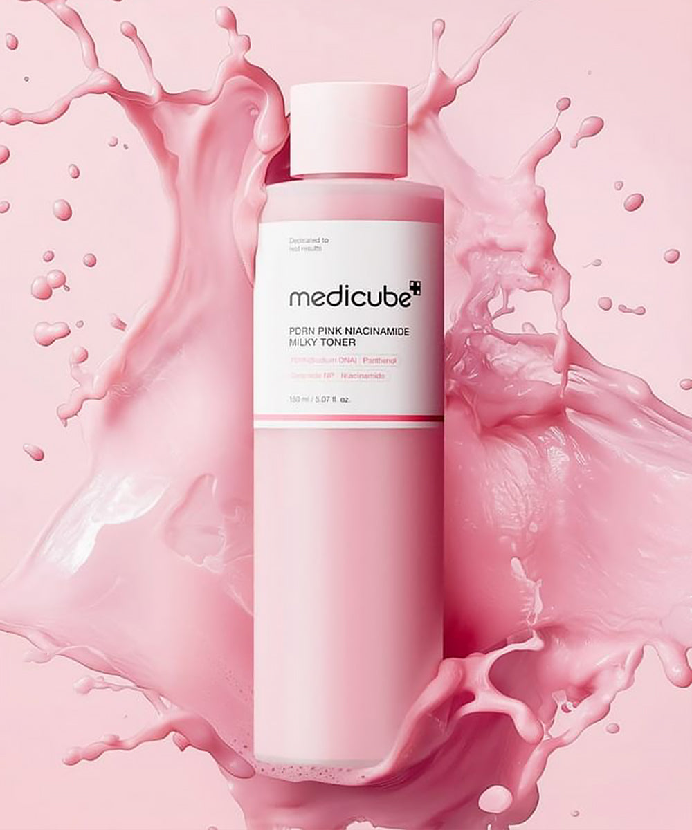 Medicube pink bottle with pink liquid splashes on a pink background