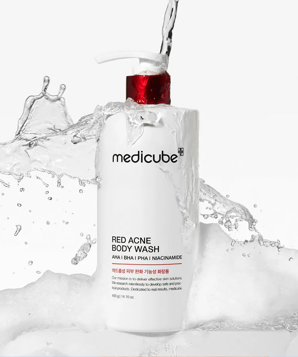 Medicube Red Acne Body Wash with water splashes on a white background