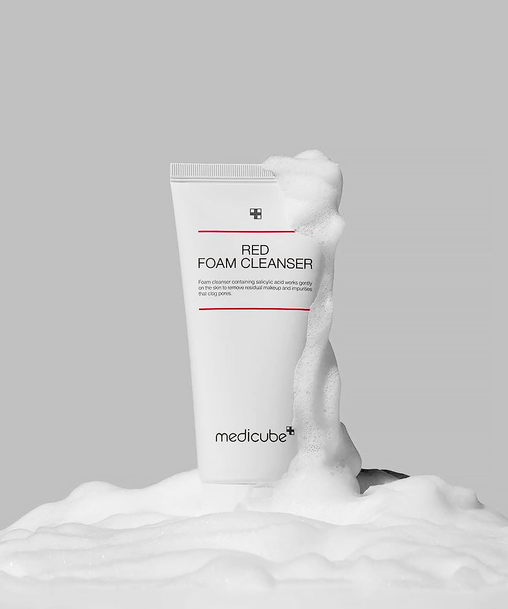 Medicube Red Foam Cleanser with foam on a gray background