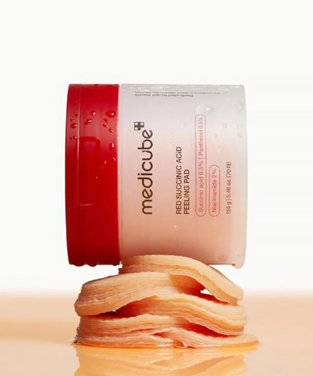 Medicube red rubber acid peeling pad with red lid on a beige background