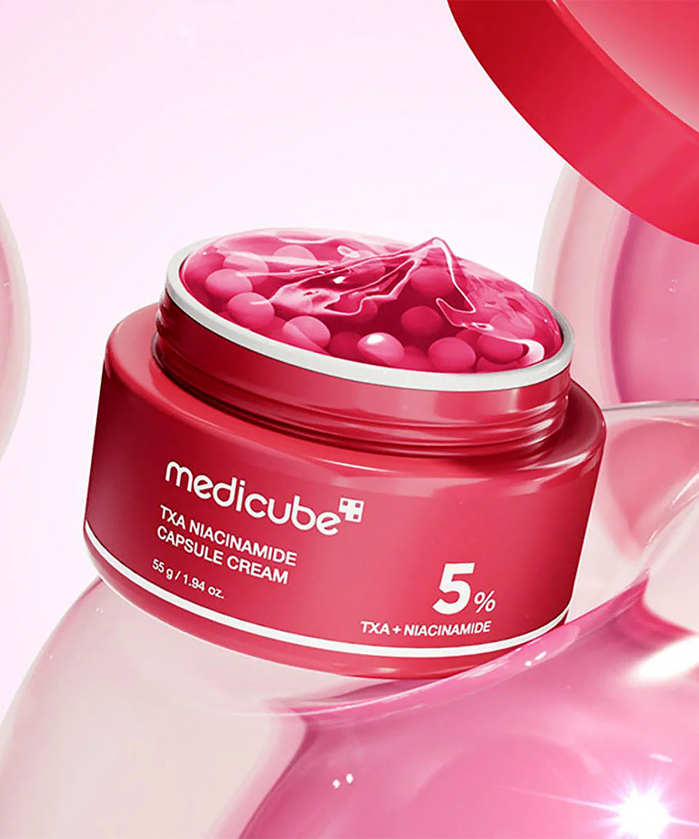 Red jar of Medicube cream with pink lid on a light pink background