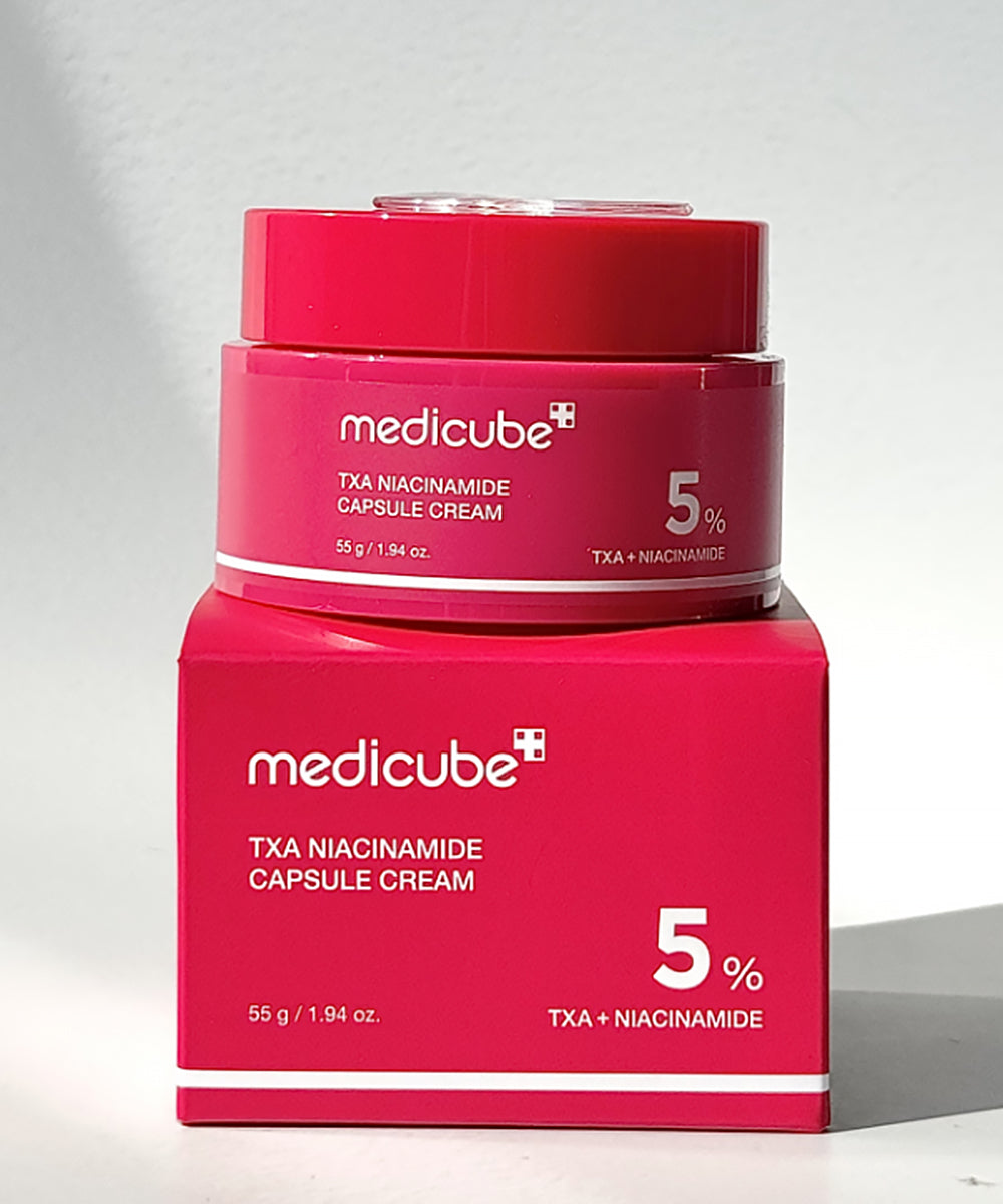 Pink jar and box of Medicube TxA Niacinamide Capsule Cream on a light gray background