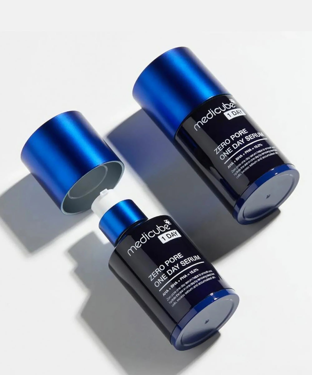 Two blue and black skincare serum bottles on a light gray background