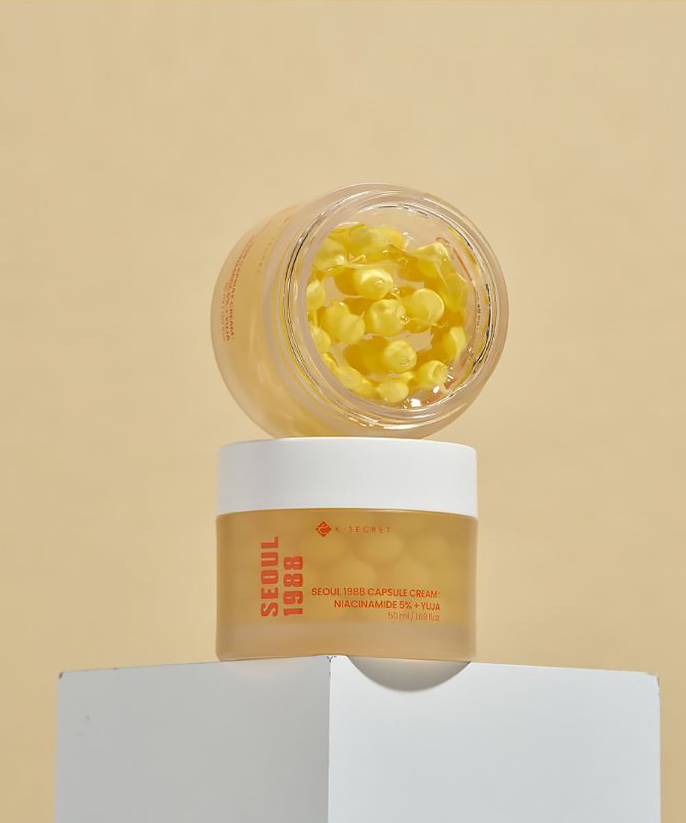 Skincare product with yellow capsules on a beige background