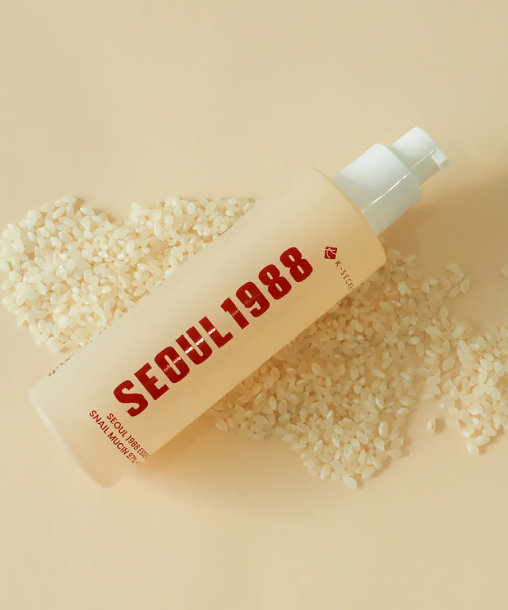 Skincare bottle labeled 'Seoul 1988' on a beige background with rice grains.