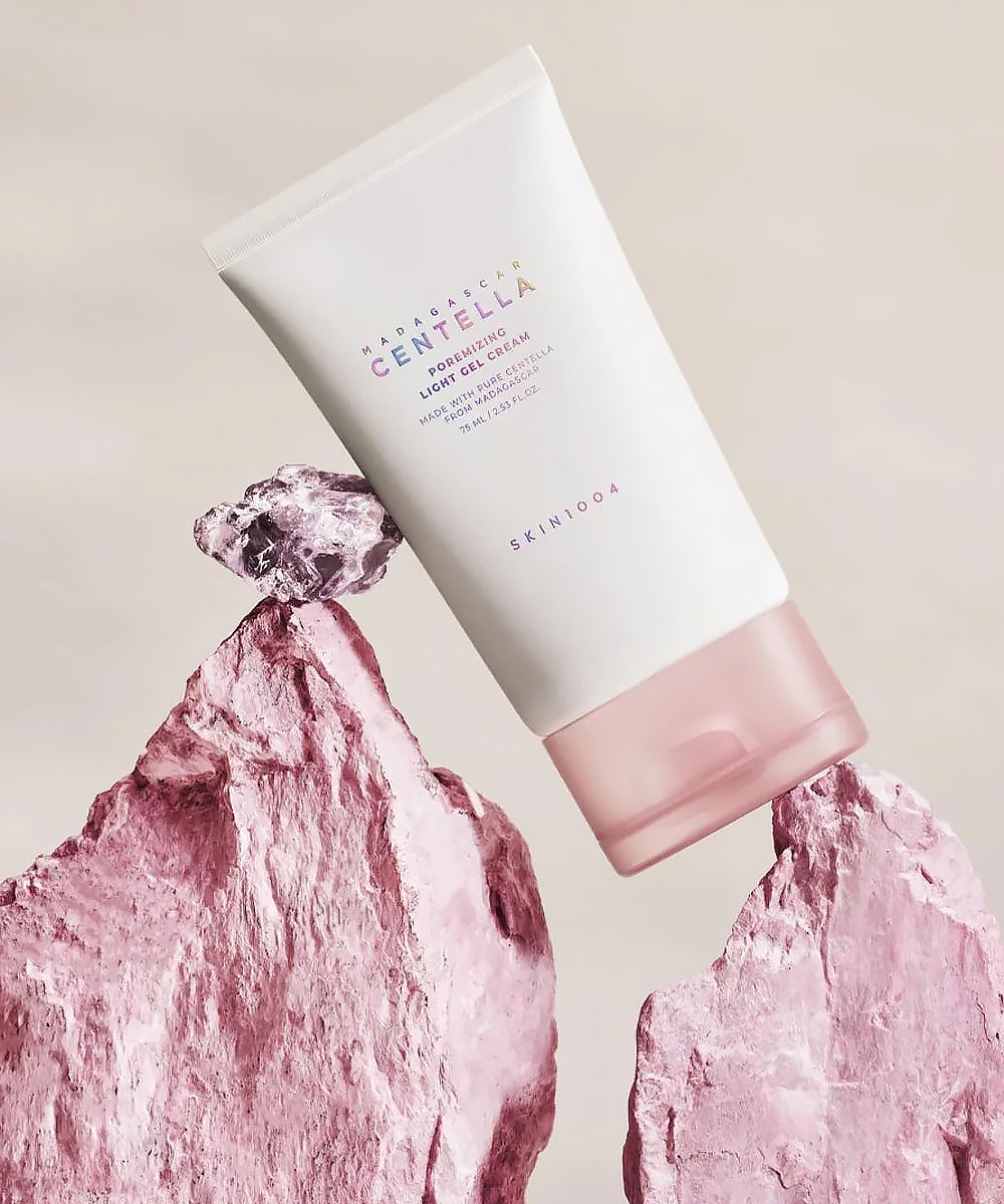 Skincare product with pink rock-like design on a beige background