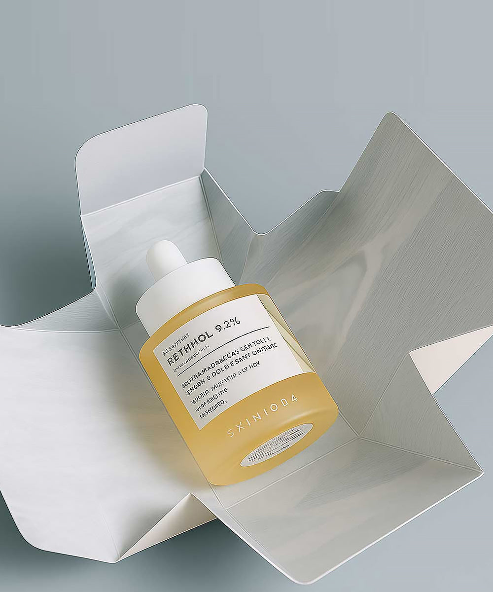 Yellow skincare bottle with dropper on a gray background