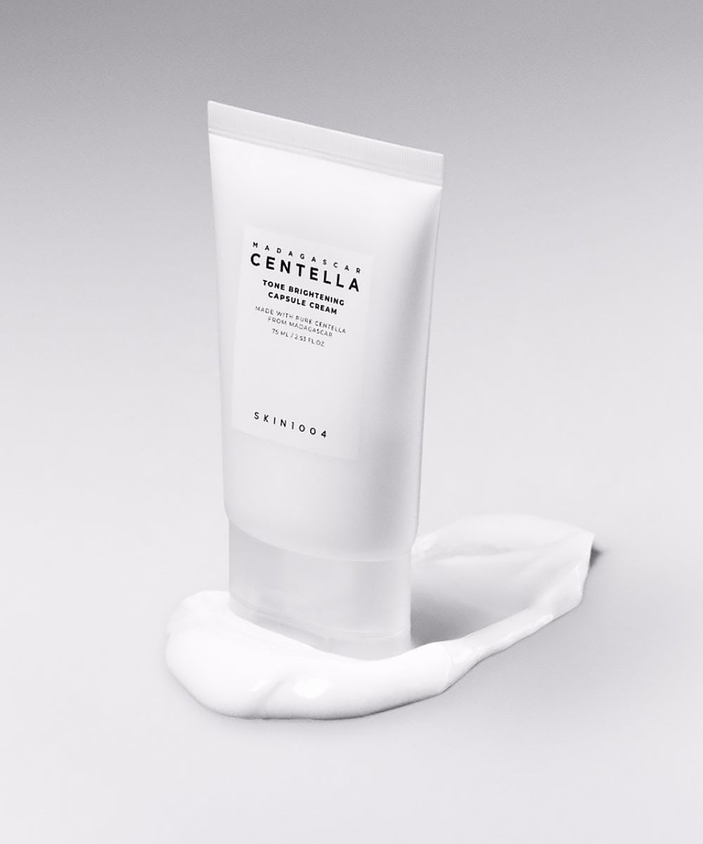 Skincare cream tube with visible brand name on a gray background