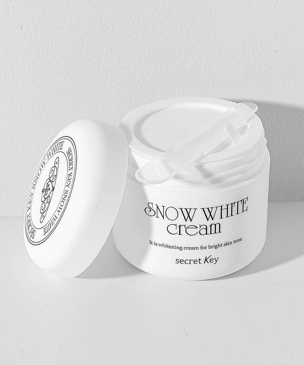 Snow White Cream jar with a white lid on a light gray background