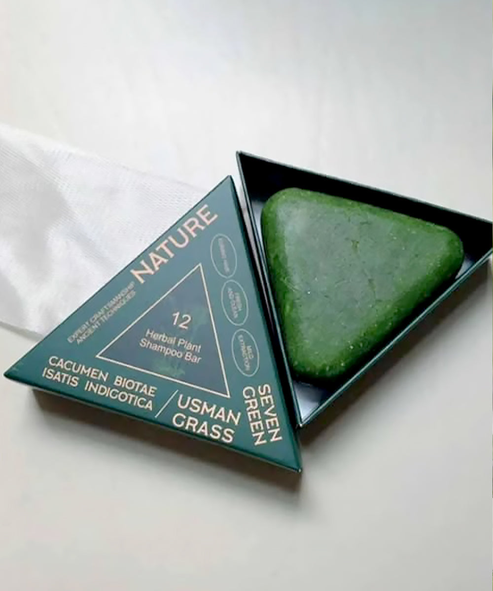 Green shampoo bar with packaging labeled 'Nature' on a white background