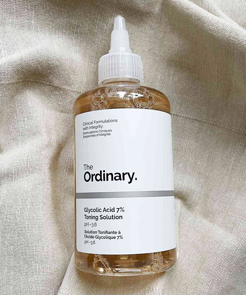 Bottle of 'The Ordinary' Glycolic Acid 7% Toning Solution on a textured beige background