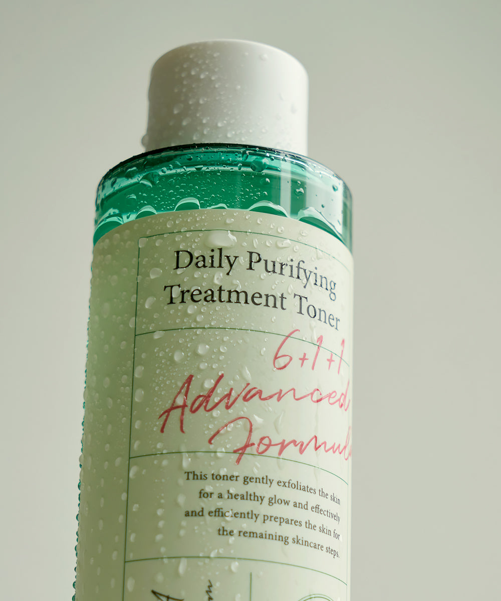 Bottle of Daily Purifying Treatment Toner with green label on a light gray background