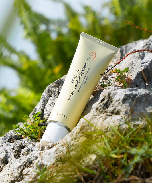 Tube of cream on a rock with greenery in the background
